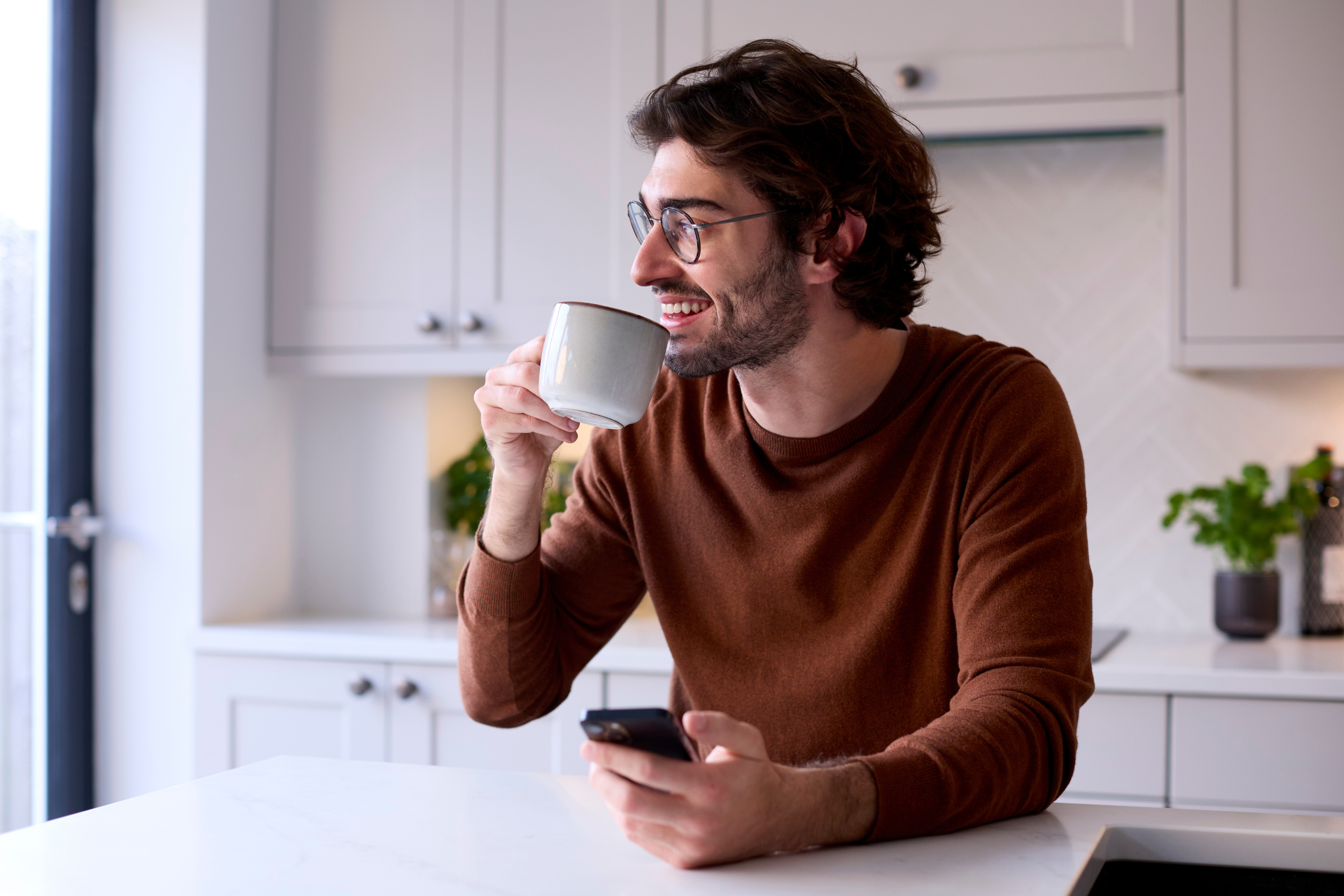 Man Relaxing Kitchen Holding Coffee, Mobile Phone