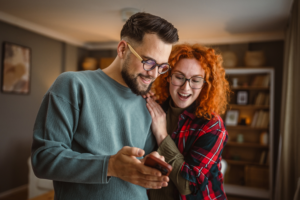 Happy Couple Wearing Glasses Home Mobile Phone