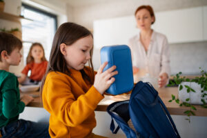 A girl packs her lunch box