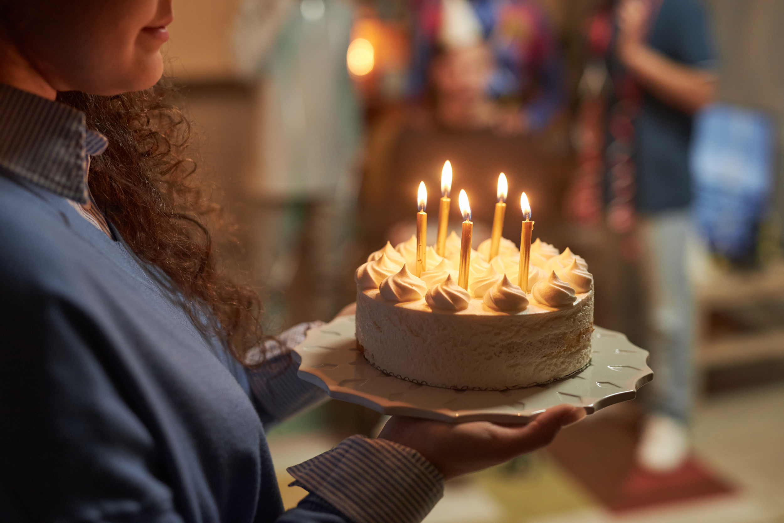 Woman Holds Birthday Cake With Candles