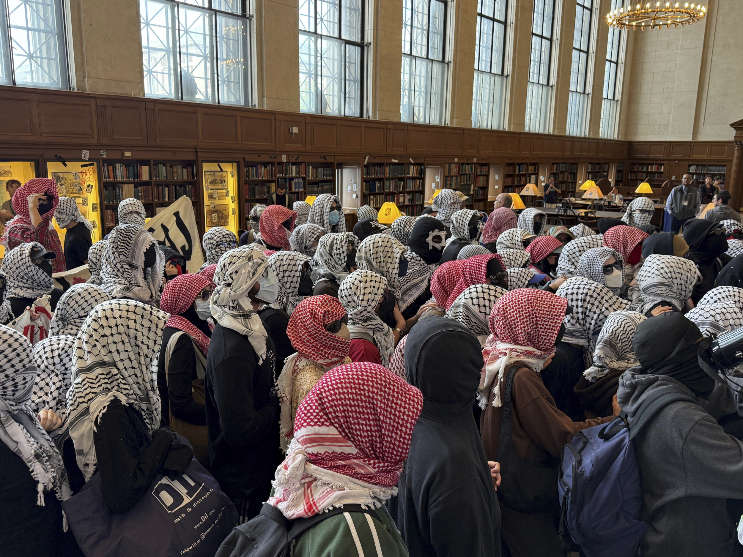 Demonstrators wearing masks protest in the library