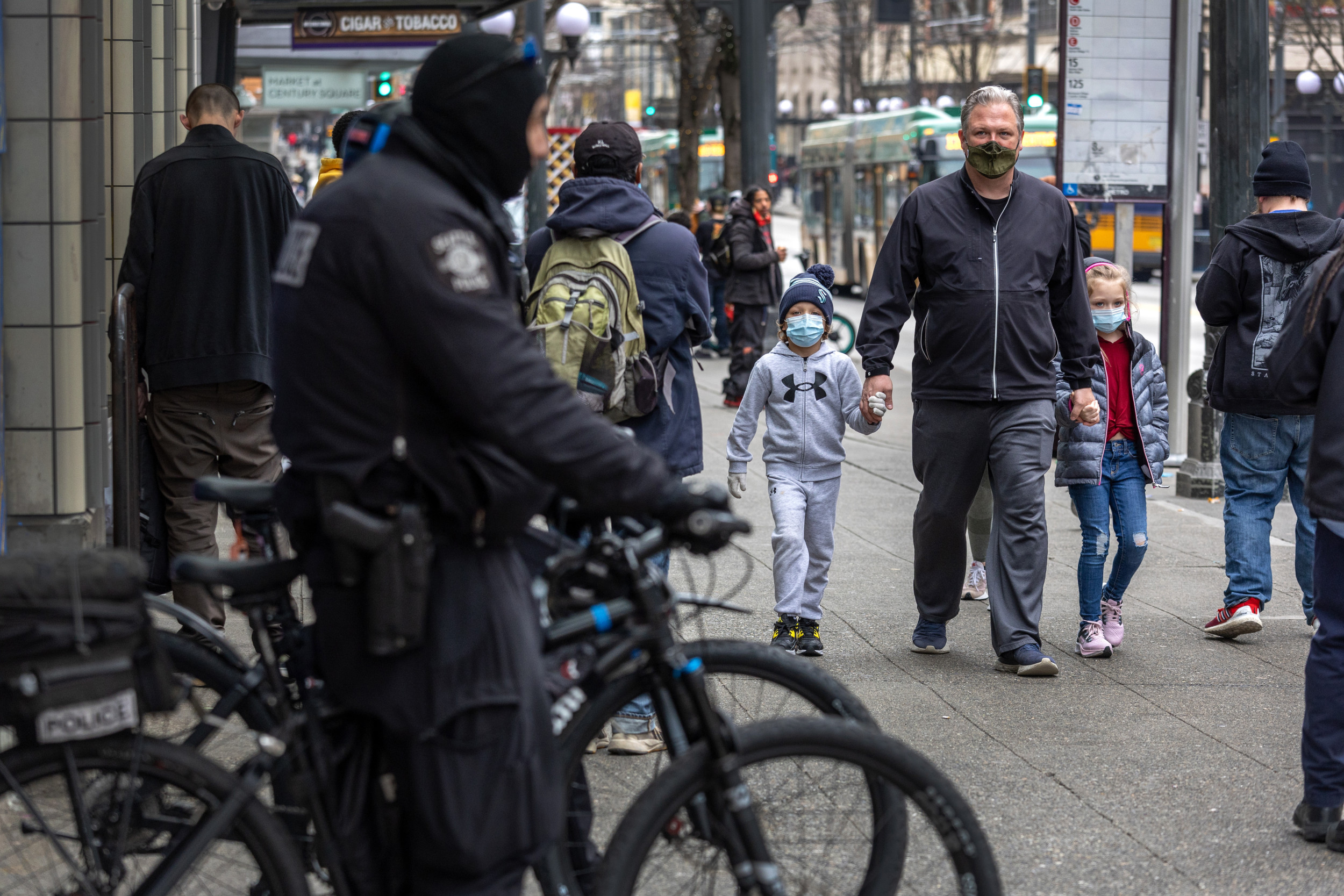 A family walks past Seattle police