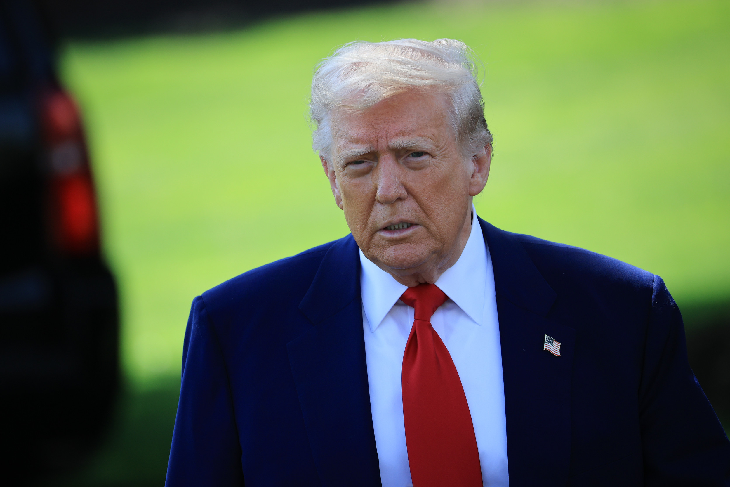 President Donald Trump walks toward members of