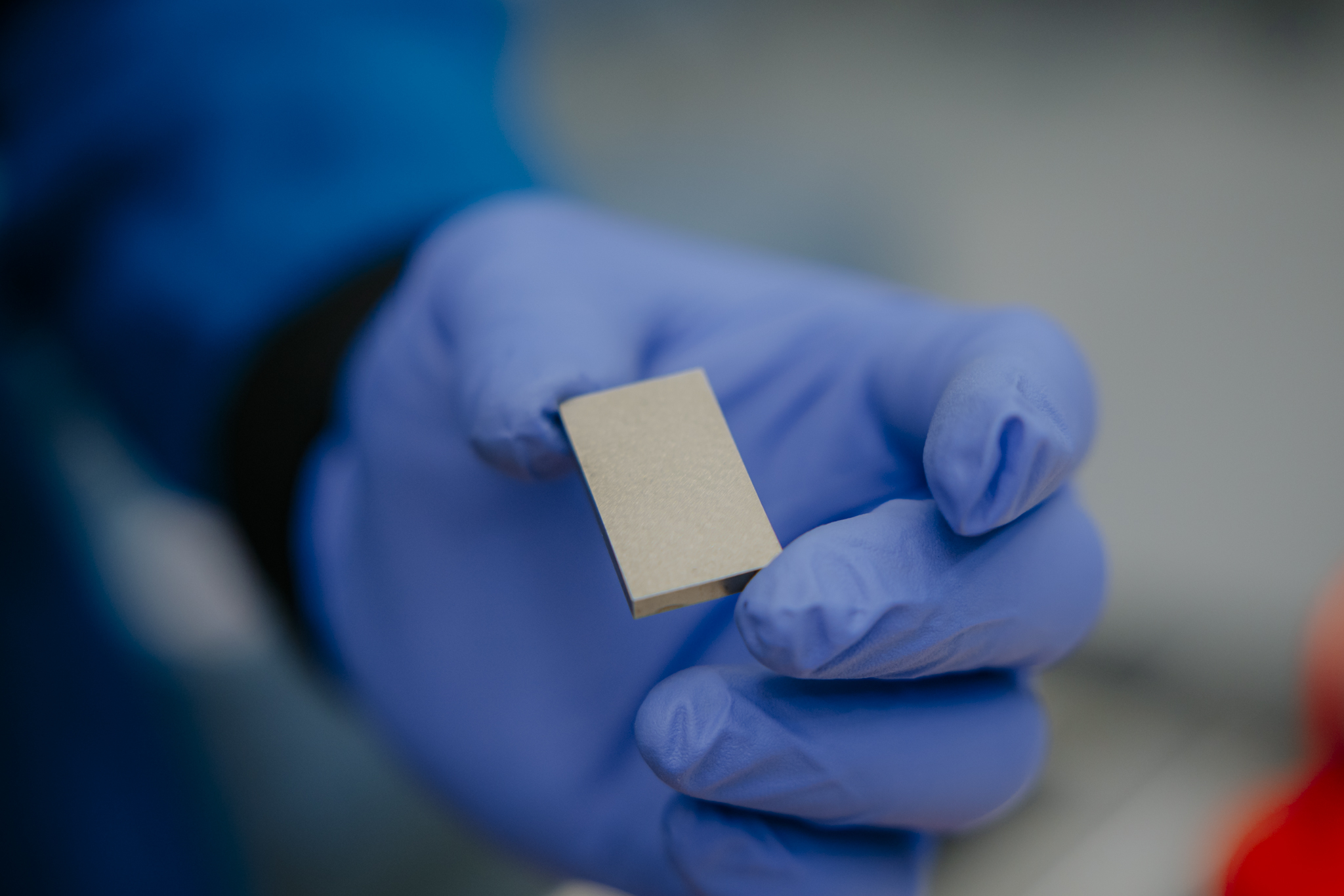 MP Materials Employee Inspects Rare Earth Magnet