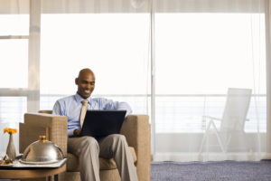 Smiling man sitting in hotel.