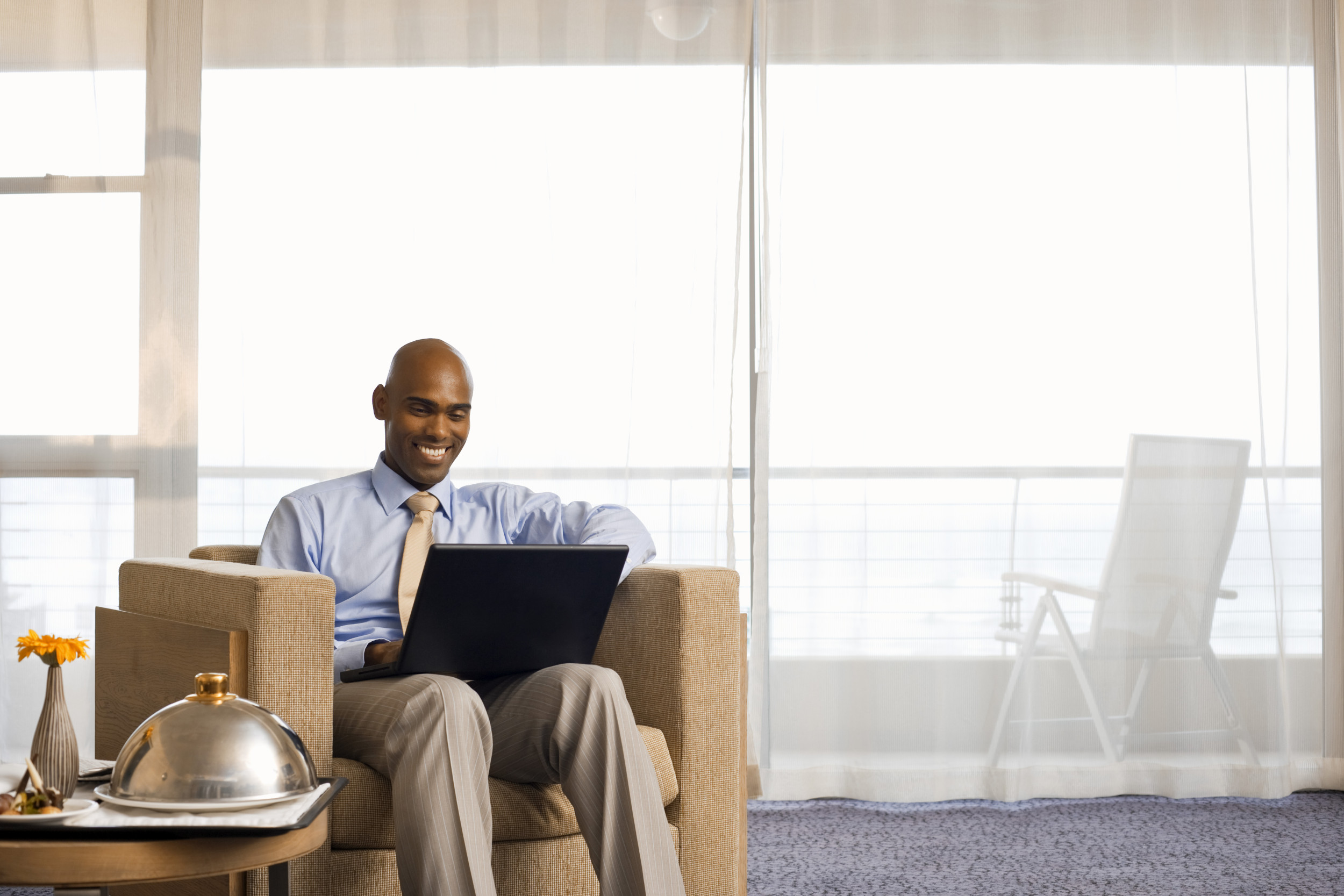 Smiling man sitting in hotel.