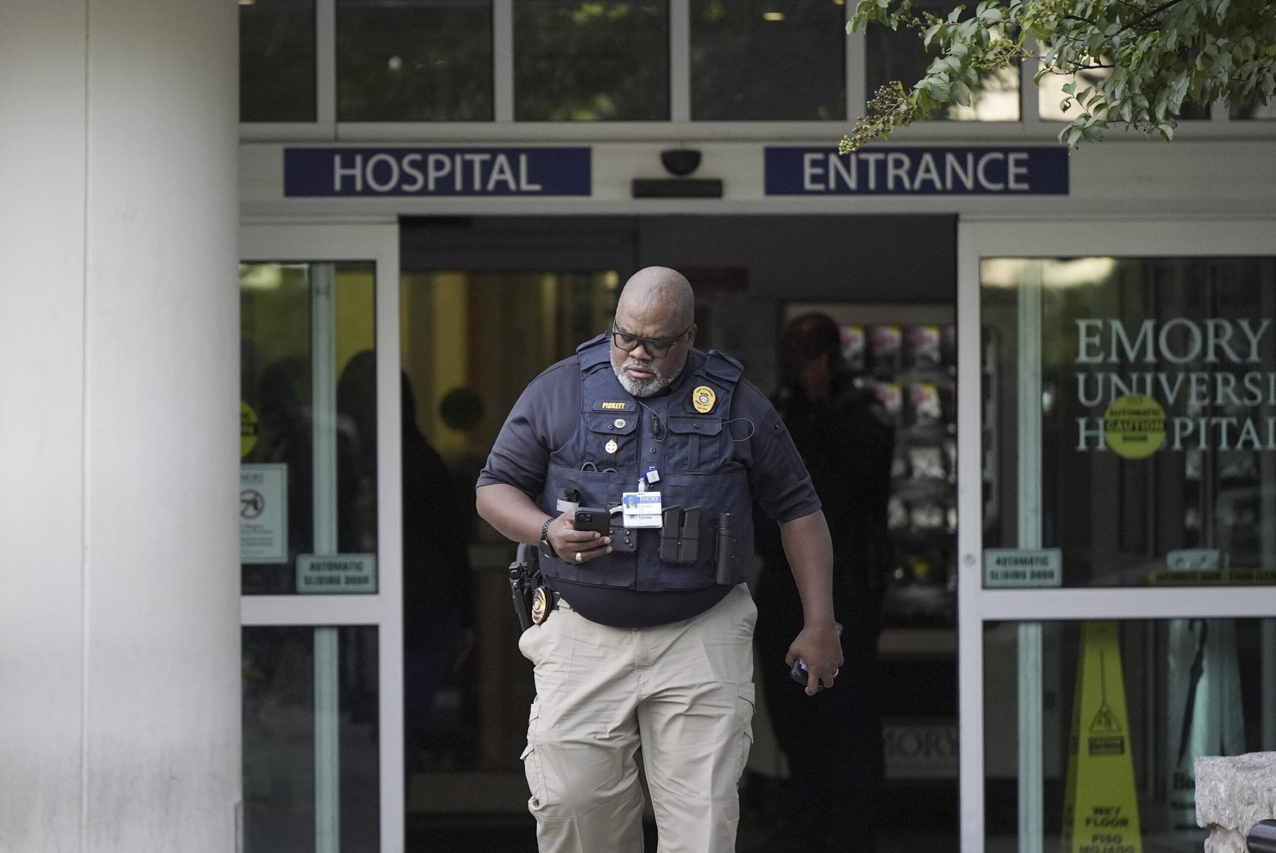 Law enforcement personnel walks out hospital